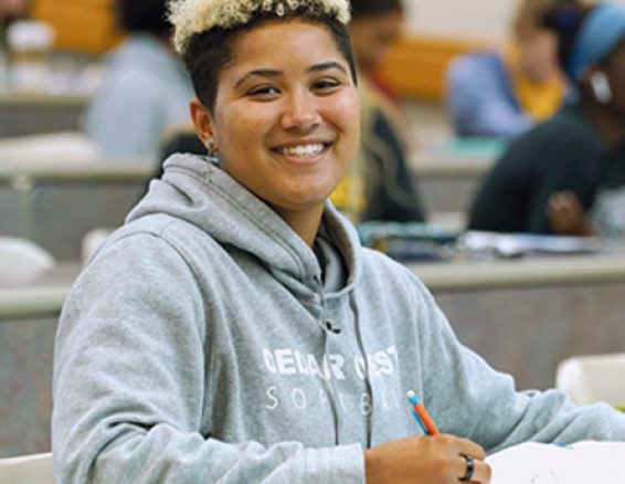 A smiling student in a classroom