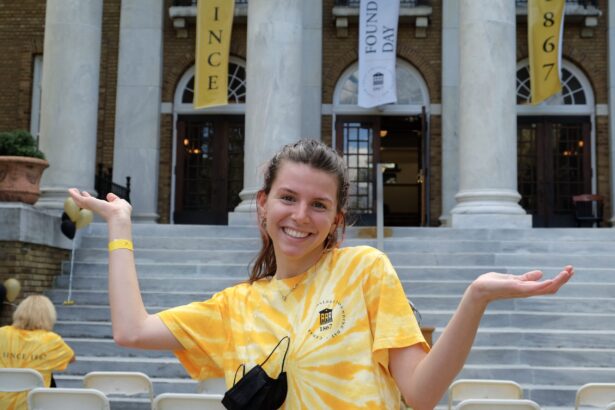 A female student smiles at 2021 Founding Day
