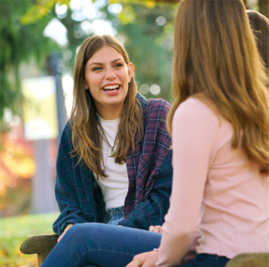 A female student laughing on campus