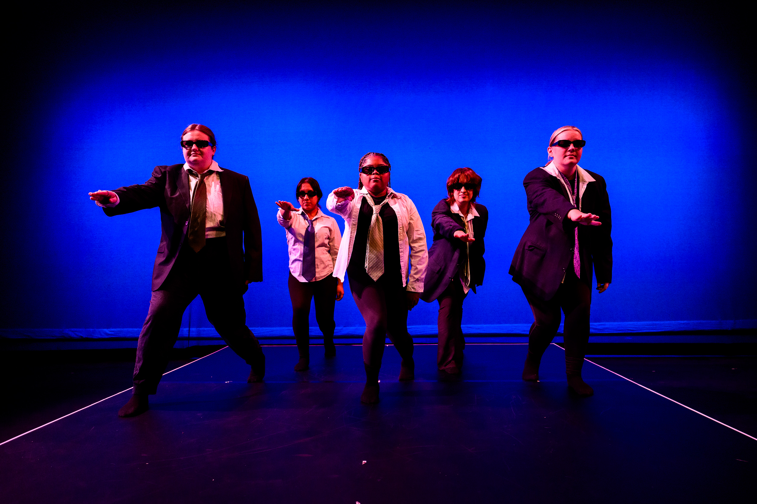 Five students in suits and sunglasses performing in the 2023 edition of DanceWorks