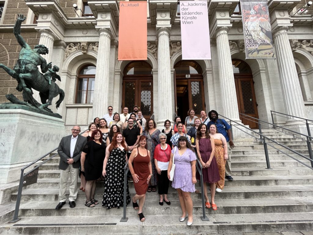 Students in the Pan-European MFA program standing on the steps of a museum