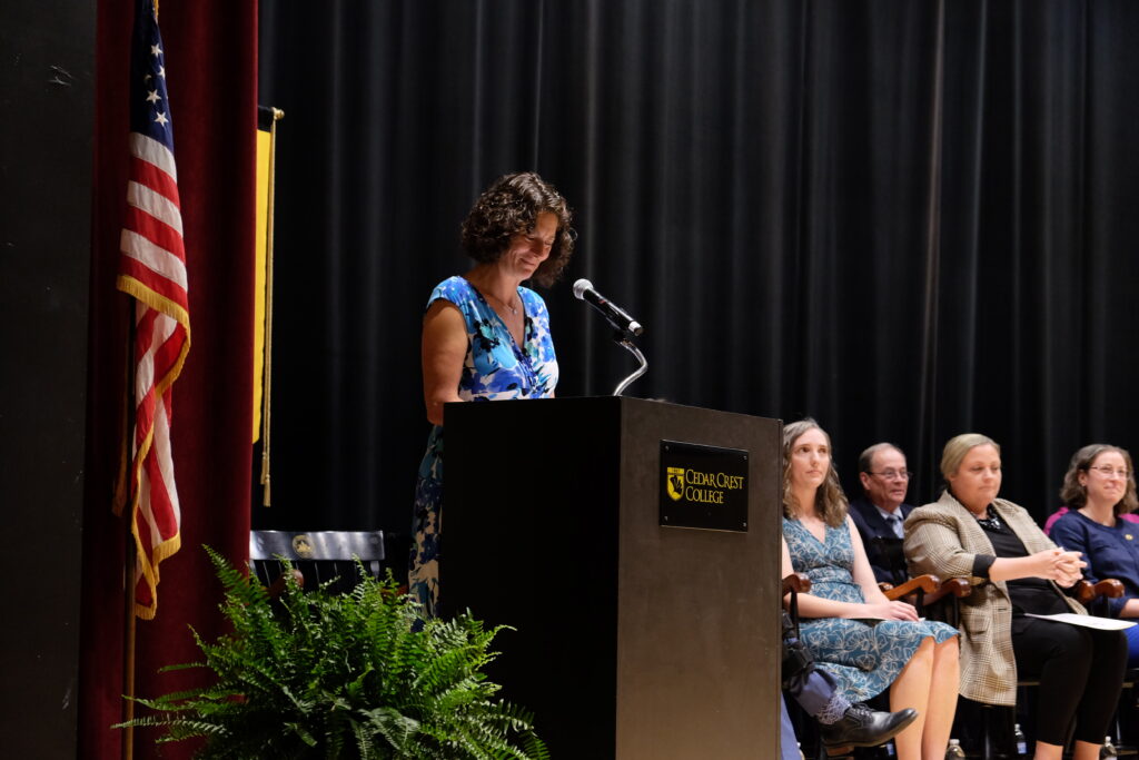 Photo of woman standing on stage at podium