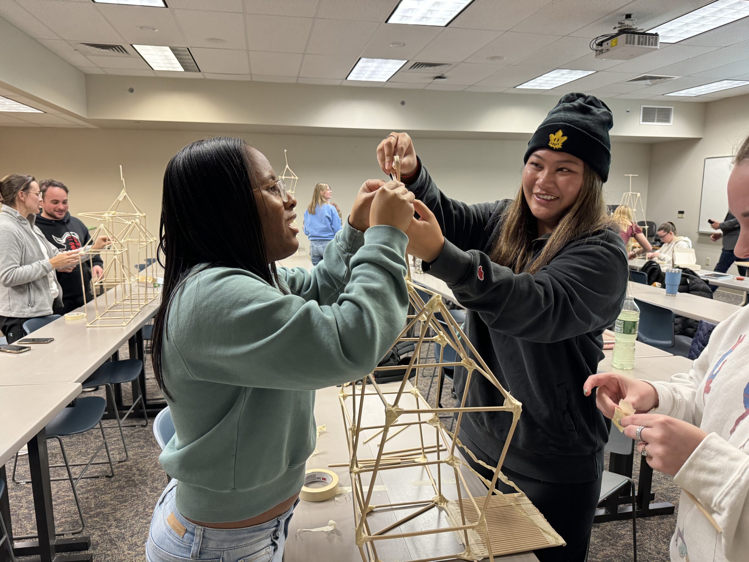 OTD students smiling and building a structure