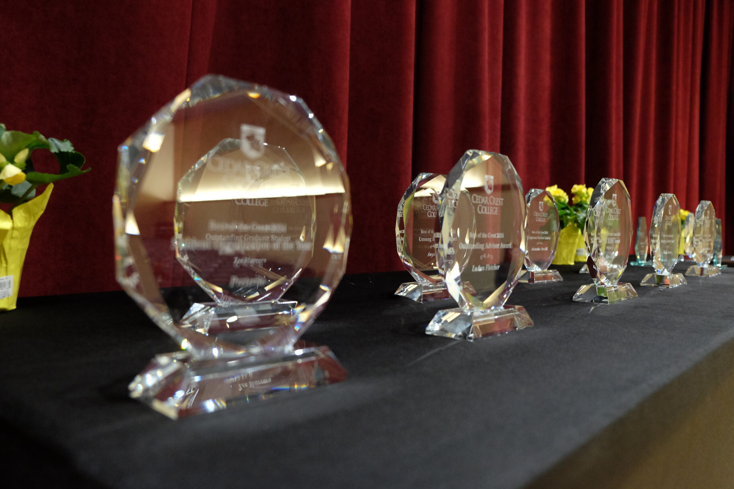 Glass awards inscribed with the Cedar Crest College crest