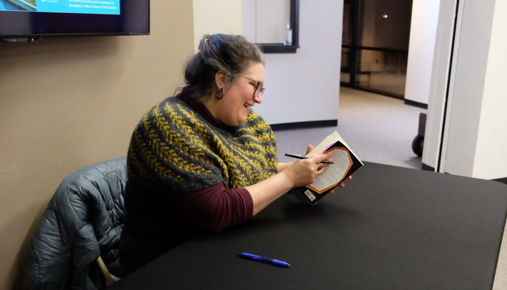 Carmen Maria Machado signing a book